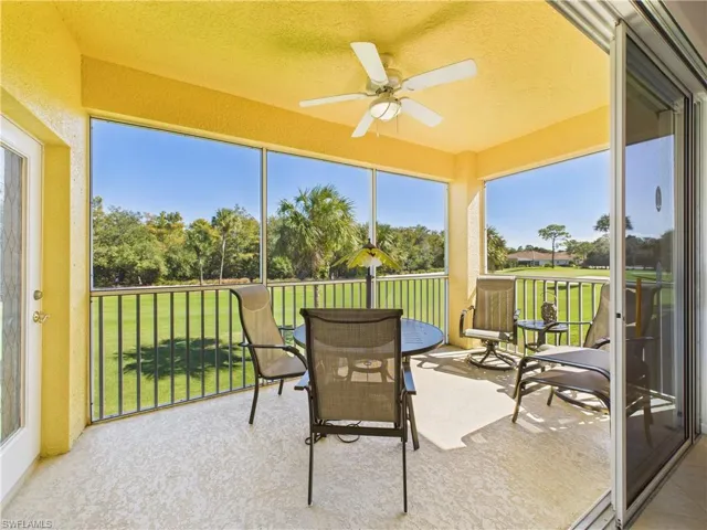 Sunroom / solarium with ceiling fan and a balcony