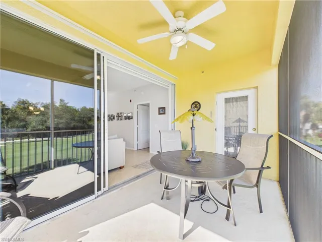 Sunroom / solarium with a ceiling fan and outdoor dining area