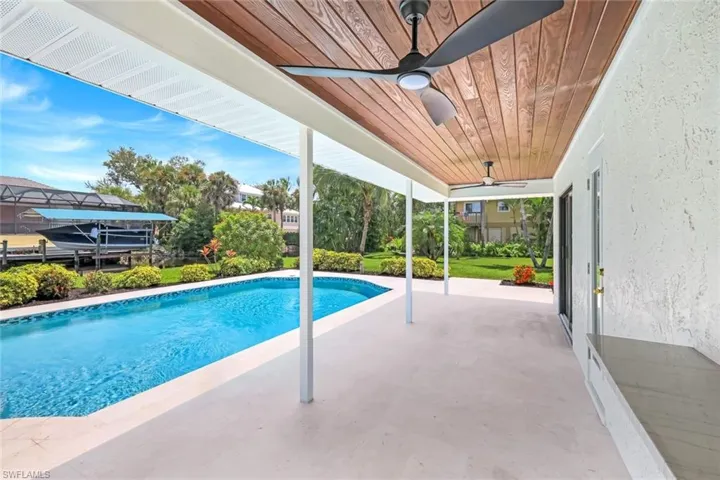 Outdoor area features completely renovated pool, plenty of room for dining and sunbathing, AND canal views! PLUS - seller will install a pool cage OR fence depending on buyer preference.