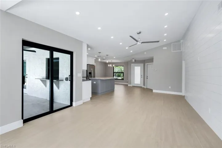Living room, kitchen, and dining area are open to one another.