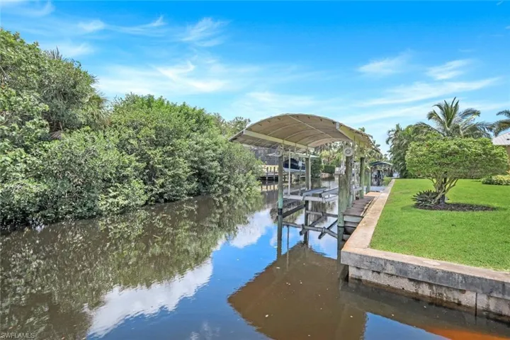 Property features a private dock, boat ramp AND a COVERED boat lift.