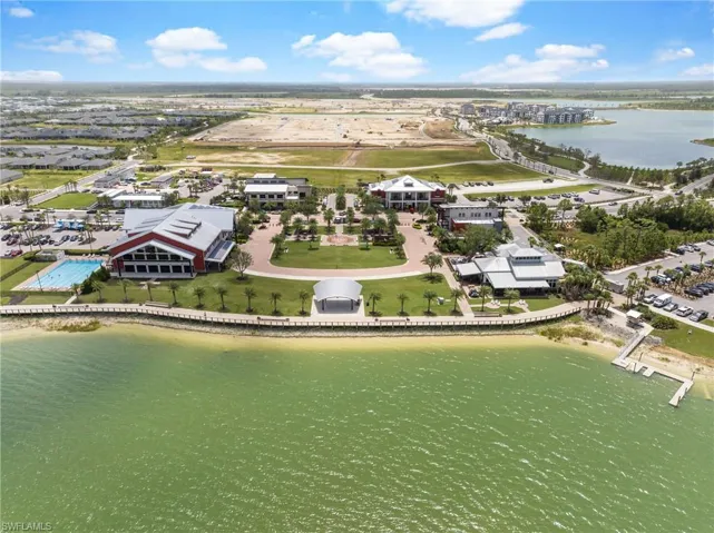 Birds eye view of property with a water view