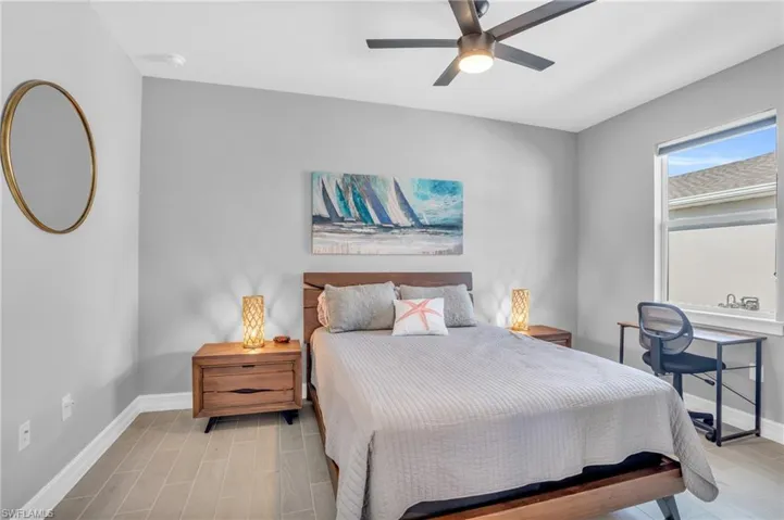 Den with ceiling fan and light hardwood / wood-style tile floors