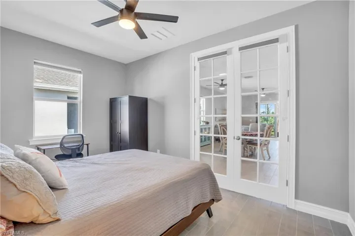 Den featuring french doors and ceiling fan