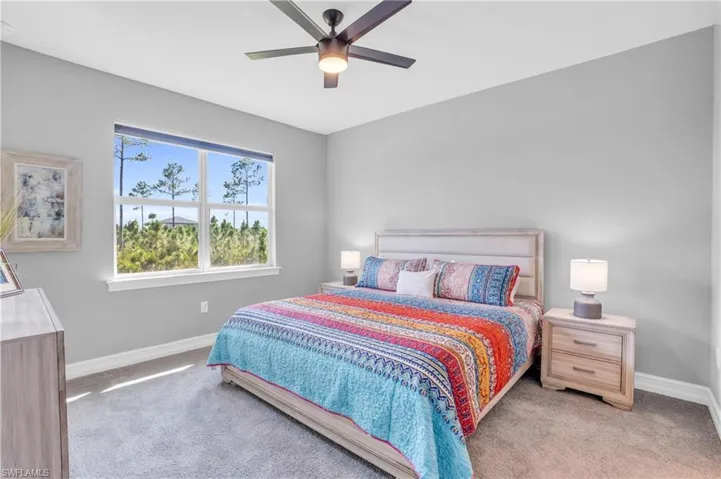 Bedroom featuring light carpet and ceiling fan
