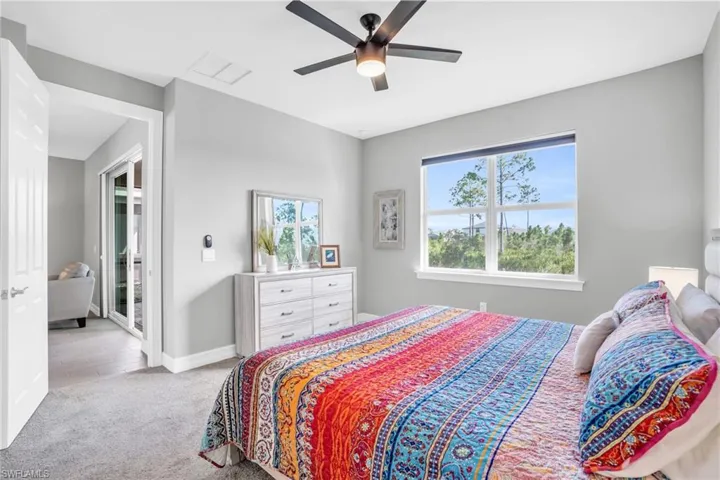 Carpeted bedroom with ceiling fan