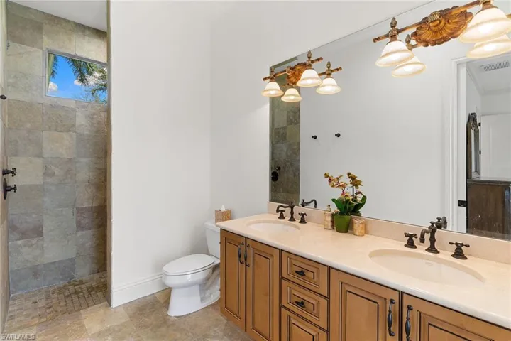Full bathroom with double vanity and walk in shower