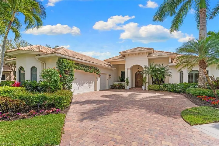 Mediterranean / spanish house with stucco siding, decorative driveway, a garage, and a tile roof
