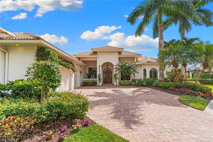 Mediterranean / spanish house featuring a garage, a tile roof, decorative driveway, and stucco siding