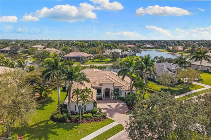Aerial perspective of suburban area featuring a nearby body of water