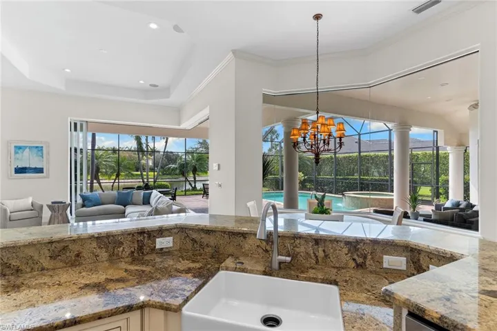 Kitchen with open floor plan, a sunroom, and crown molding