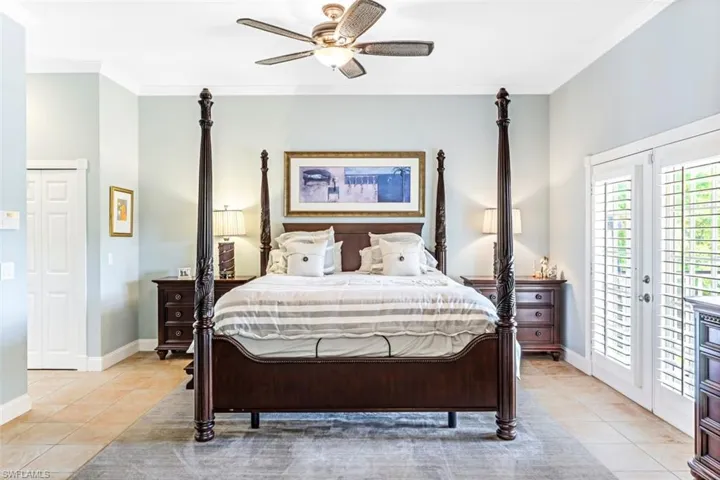 Bedroom with ceiling fan, access to outside, ornamental molding, french doors, and light tile patterned floors