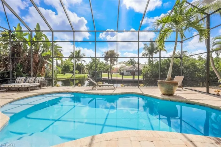 View of swimming pool with a patio area and a lanai