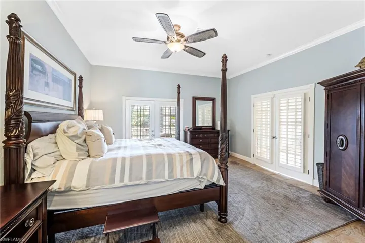 Bedroom featuring ceiling fan, ornamental molding, french doors, and access to exterior