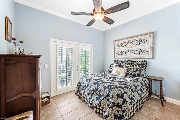 Bedroom featuring light tile patterned floors, ornamental molding, french doors, access to exterior, and ceiling fan