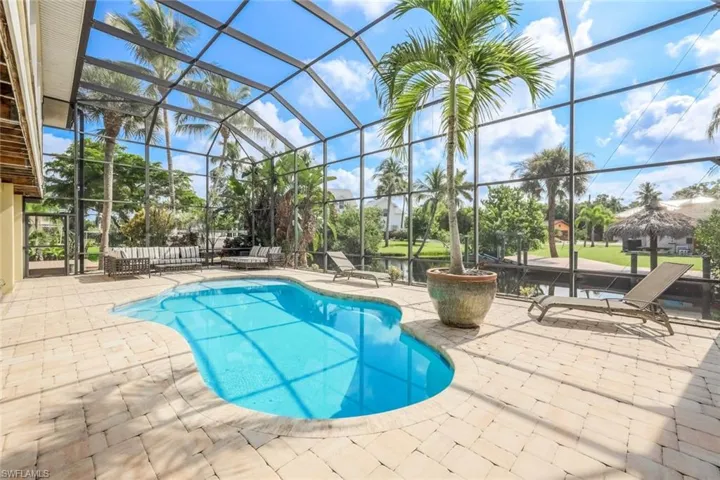 View of swimming pool featuring a patio area and a lanai