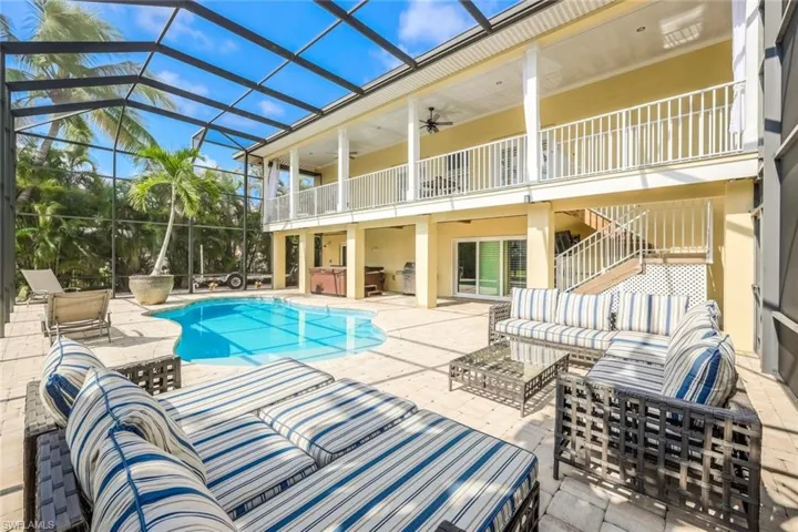 View of swimming pool with an outdoor living space, a patio, a lanai, and ceiling fan