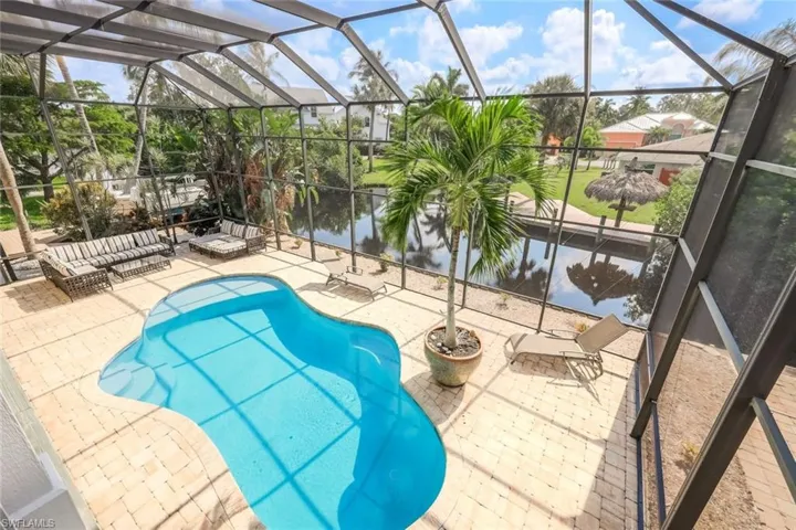 View of swimming pool featuring a patio and a lanai