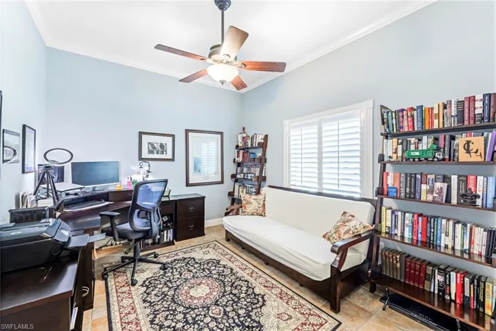 Tiled office with ceiling fan and ornamental molding