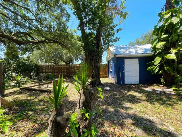 Fenced backyard with an outbuilding
