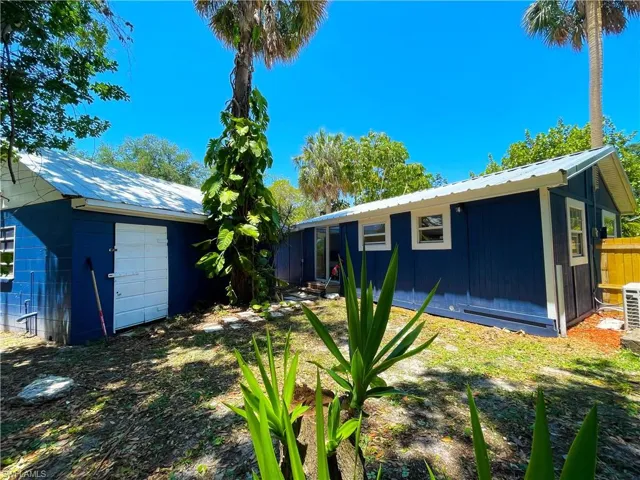 Rear view of house with a metal roof and concrete block siding