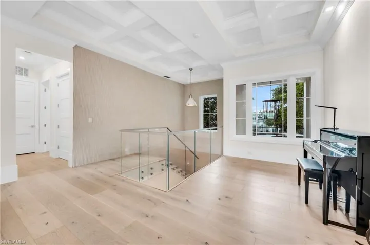 Glass stairway railings leading to the upstairs family room