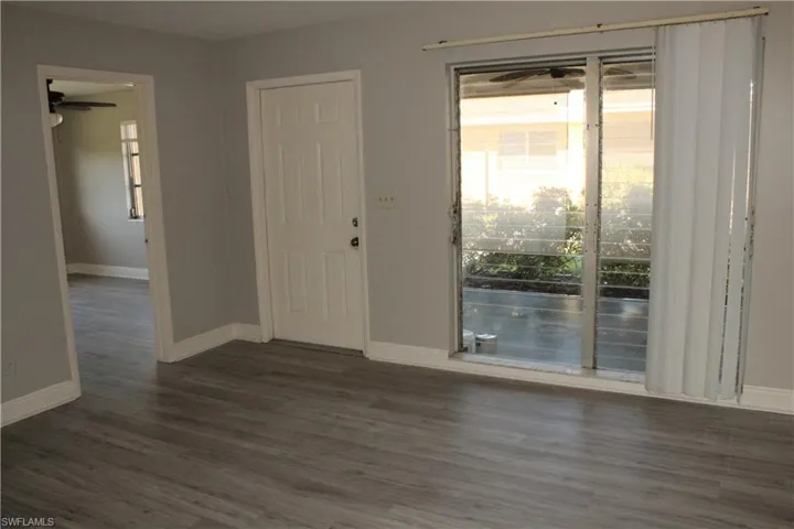 Entryway featuring ceiling fan and dark hardwood / wood-style floors