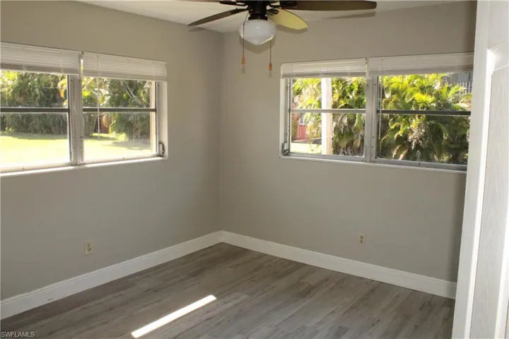 Spare room featuring dark hardwood / wood-style floors and ceiling fan