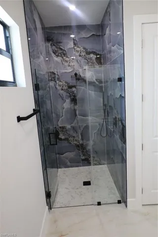 Full bathroom featuring a marble finish shower