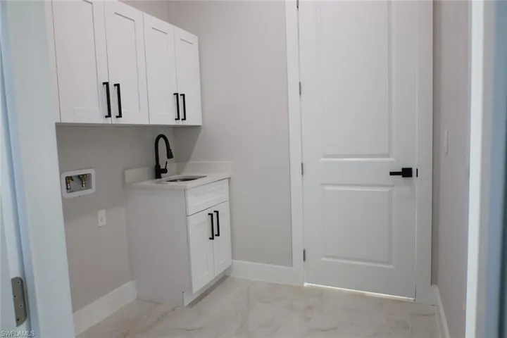 Laundry area with cabinet space and hookup for a washing machine