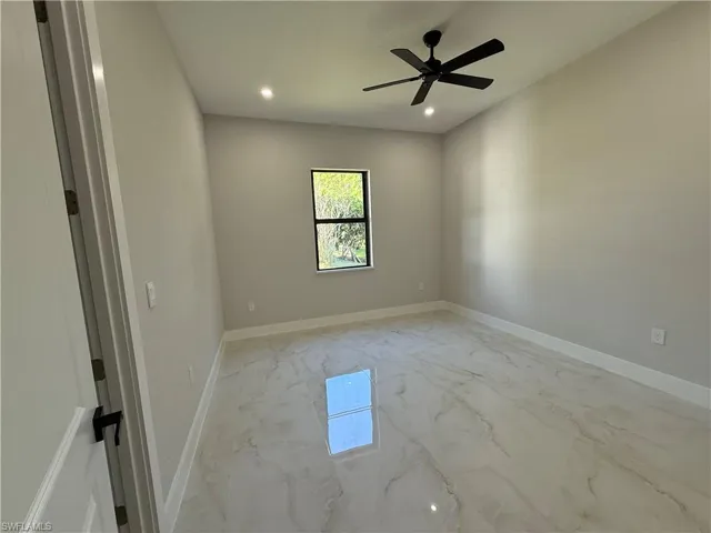 Spare room featuring light marble finish flooring, recessed lighting, and ceiling fan