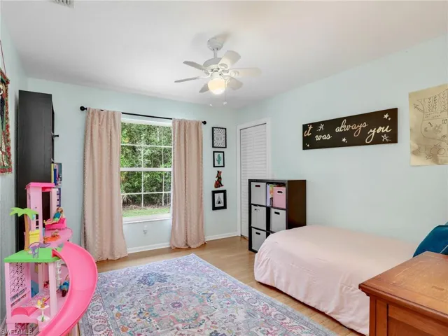 Bedroom with wood finished floors and a ceiling fan