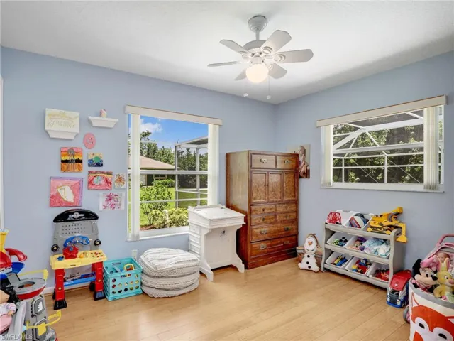 Game room featuring wood finished floors, plenty of natural light, and a ceiling fan