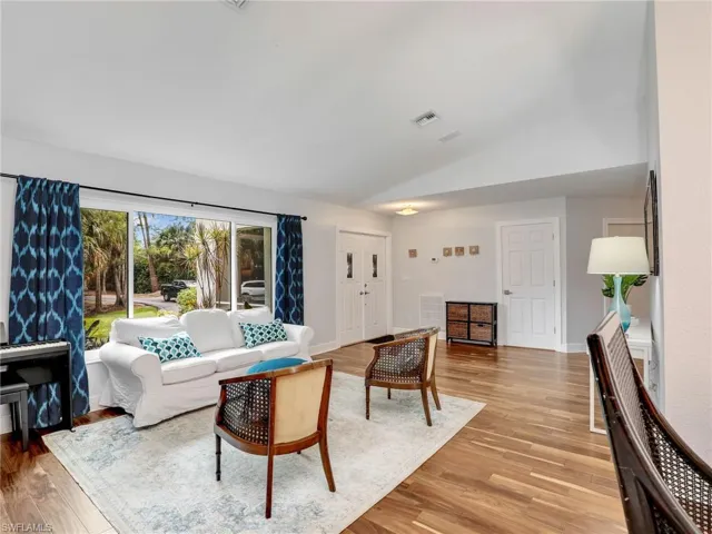 Living area featuring vaulted ceiling and light wood-type flooring