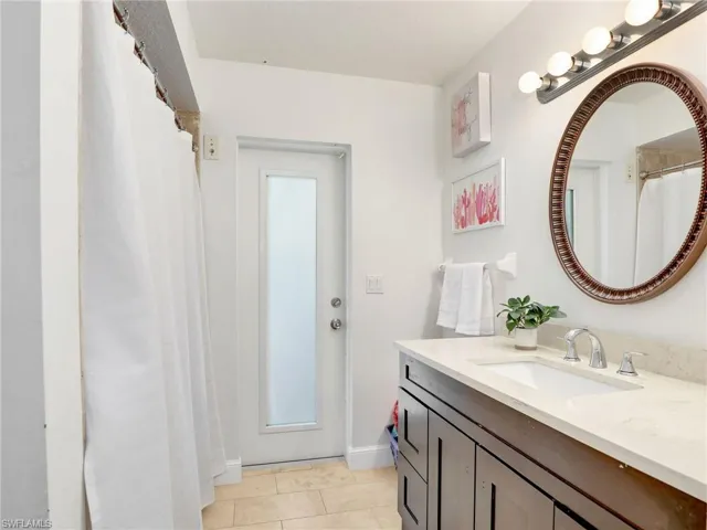 Full bathroom featuring vanity and tile patterned floors