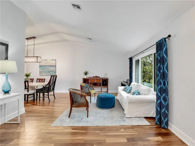 Living area featuring lofted ceiling and wood finished floors