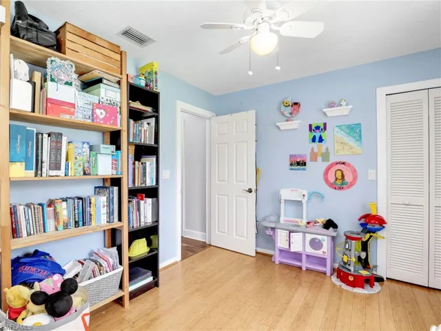 Rec room with wood finished floors and ceiling fan