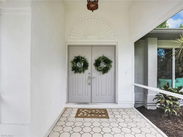 Screened entry to property featuring double doors