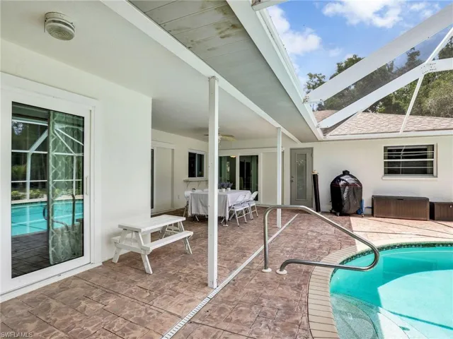 Outdoor pool featuring a patio, a ceiling fan, and outdoor dining space