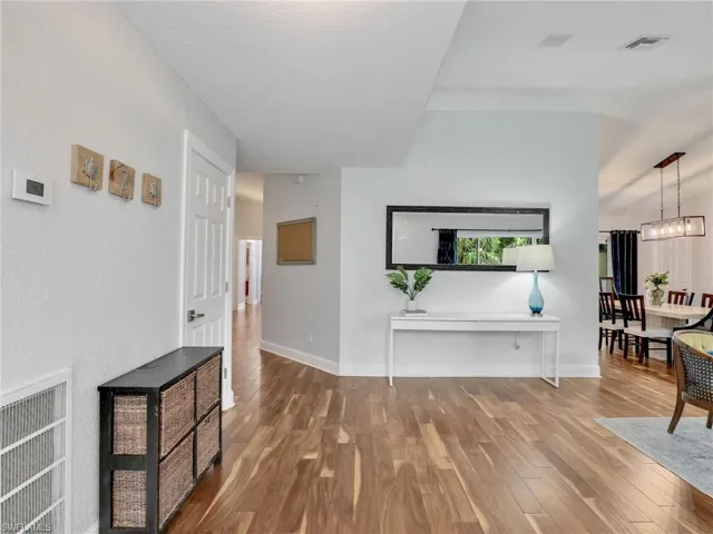 Entry featuring Acacia wood finished floors