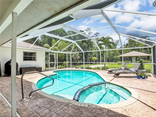 View of swimming pool with a patio and a pool with connected hot tub