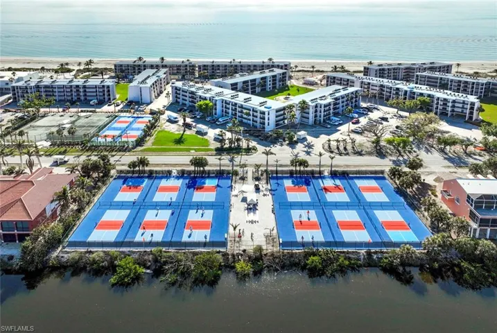 Birds eye view of property with a water view