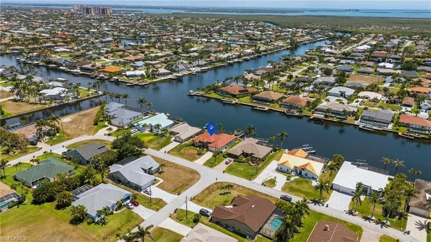 Birds eye view of property with a residential view and a water view