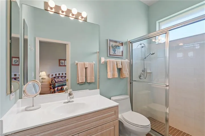 Ensuite bathroom with vanity, a stall shower, toilet, and ensuite bath