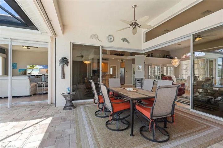 Dining area with stone tile floors, a ceiling fan, and visible vents