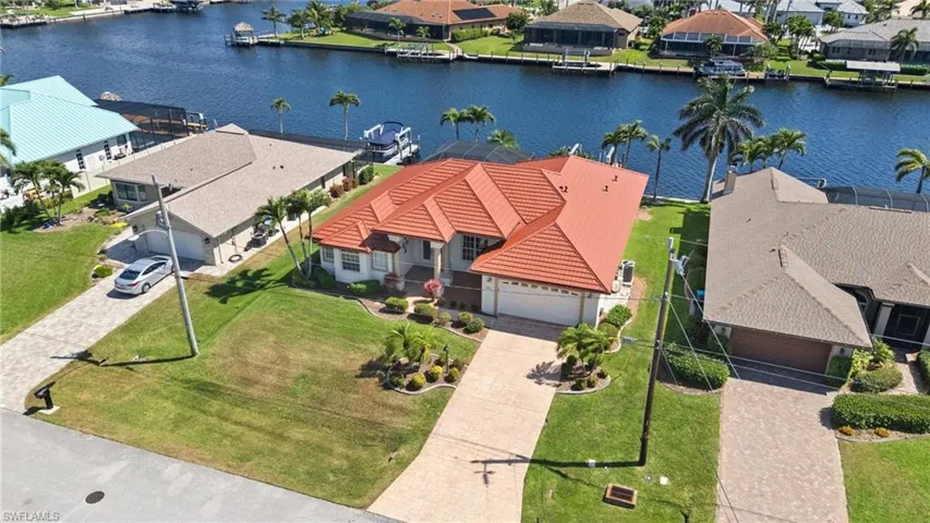 Birds eye view of property with a water view and a residential view
