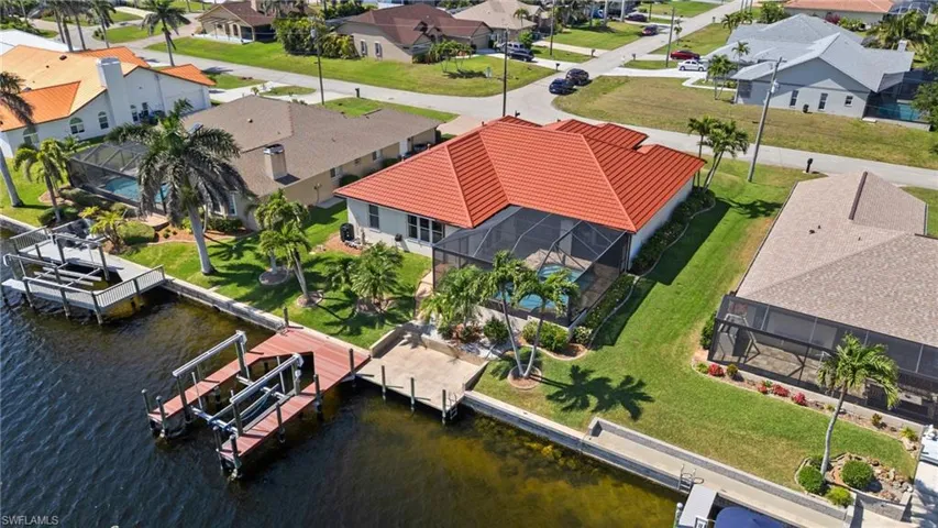 Birds eye view of property with a water view and a residential view