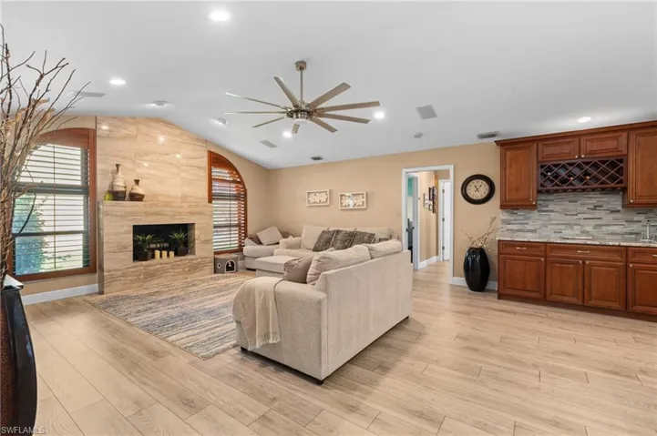 Living Area with Fireplace and Adjoining Wet Bar