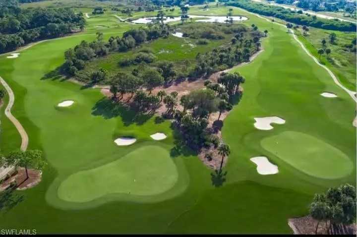 Aerial view of property and surrounding area with a local golf course