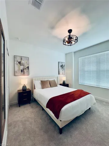 Bedroom with carpet flooring and baseboards